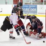 Juneau-Douglas Cully Corrigan scores on North Poles goalie Moses Halbert as his helmet is knocked away by North Poles Jeff Doty at Treadwell Arena on Friday, Jan. 19, 2018.