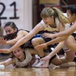 Thunder Mountains Kyaye Garcia, left, dives for a loose ball against Juneau-Douglas Kiana Potter, bottom left, Caitlin Pusich and Alyxn Bohulano, right, at JDHS on Friday, March 3, 2018. JDHS won 53-33.