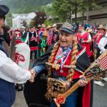 Marvin Kadake, right, of the Keex Kwaan Dancers (People of Kake) shakes hands with Ed Kunz during the Grand Entrance for Celebration 2018 along Willoughby Avenue on Wednesday, June 6, 2018. Kadake is a Medal of Honor veteran who served in Korea with the Marines. (Michael Penn | Juneau Empire)