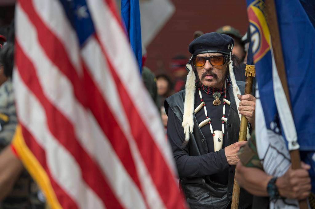 Wayne Smallwood lines up with the Southeast Alaska Native Veterans honor guard to lead dance groups parade through downtown Juneau on Saturday, June 9, 2018, the last day of Celebration 2018. (Michael Penn | Juneau Empire)