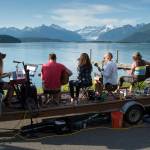 Juneau residents listen to the music of Papertrails and enjoy the beach during a solstice party at the North Douglas Boat Launch on Wednesday, June 20, 2018. (Michael Penn | Juneau Empire)