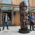 Tsimshian artist David R. Boxley, left, Tlingit artist Stephen Jackson, center, and Haida artist TJ Young, stand by their bronze house posts during an unveiling ceremony in front of the Walter Soboleff Center by Sealaska Heritage Institute on Sunday, Aug. 26, 2018. (Michael Penn | Juneau Empire)
