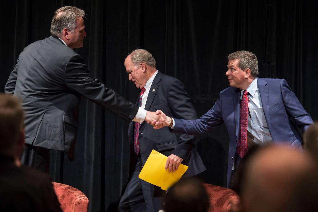 Former state Senate Mike Dunleavy, left, Gov. Bill Walker, center, and former U.S. Senator Mark Begich shake hands after a debate at a Juneau Chamber of Commerce luncheon at Centennial Hall on Thursday, Sept. 6, 2018. (Michael Penn | Juneau Empire)
