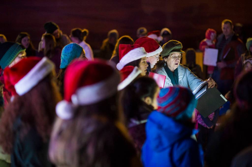 Members of The Voices of Alaska, directed by Missouri Smyth, sing Christmas carols at the annual Douglas Christmas Tree lighting at the Douglas Community United Methodist Church on Friday, Nov. 23, 2018. (Michael Penn | Juneau Empire)