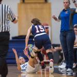 Thunder Mountains Mary Neal Garcia falls and is called for a foul against North Poles Laura Donovan at TMHS on Thursday, Dec. 13, 2018. TMHS won 57-39. (Michael Penn | Juneau Empire)