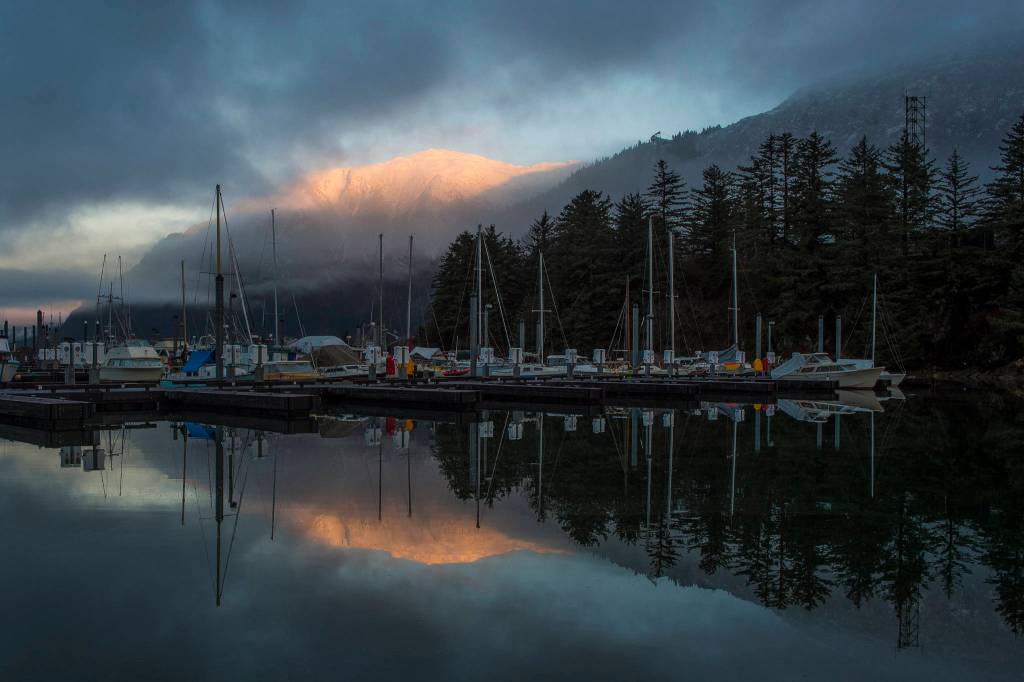 Mount Juneau catches the first rays of sunrise as seen from the Mike Pusich Douglas Boat Harbor on Thursday, Jan. 3, 2019. (Michael Penn | Juneau Empire)