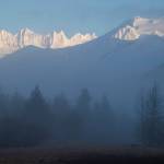 The Mendenhall Towers light up during sunrise as fog rolls off the Mendenhall River on Thursday, Jan. 3, 2019. (Michael Penn | Juneau Empire)