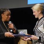 Sherry Patterson, ROAR Womens Conference Chair, presents Elizabeth Smart with a gift Jan. 11, 2019. (Ben Hohenstatt | Juneau Empire)