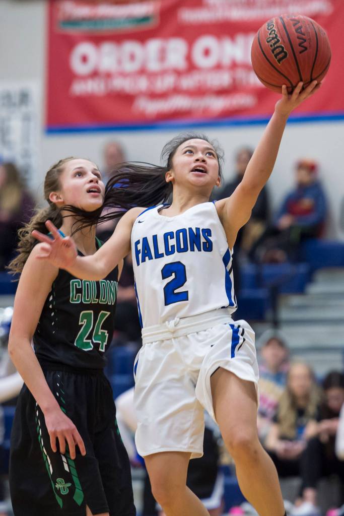 Thunder Mountains Mary Khaye Garcia shoots against Colonys Maggie Spencer at TMHS on Friday, Jan. 11, 2019. Colony won 58-28. (Michael Penn | Juneau Empire)