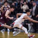 Juneau-Douglas Israel Yadao, right, races Ketchikans James Nordlund down the court at JDHS on Friday, Jan. 11, 2019. JDHS won 75-67. (Michael Penn | Juneau Empire)