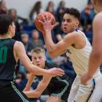 Thunder Mountains Kamron Falls, right, is pressured by Colonys Jeremiah Hersrud, left, and Colton Spencer at TMHS on Friday, Jan. 11, 2019. Colony won 46-27. (Michael Penn | Juneau Empire)