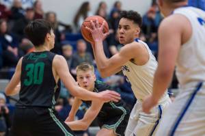 Thunder Mountains Kamron Falls, right, is pressured by Colonys Jeremiah Hersrud, left, and Colton Spencer at TMHS on Friday, Jan. 11, 2019. Colony won 46-27. (Michael Penn | Juneau Empire)