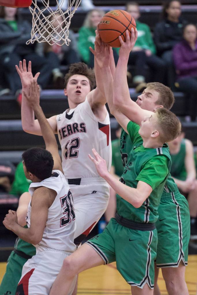 Juneau-Douglas Brock McCormick, left, goes up for a rebound against Colonys Wyatt Baker and Colton Spencer at JDHS on Thursday, Jan. 10, 2019. Colony won 66-40. (Michael Penn | Juneau Empire}