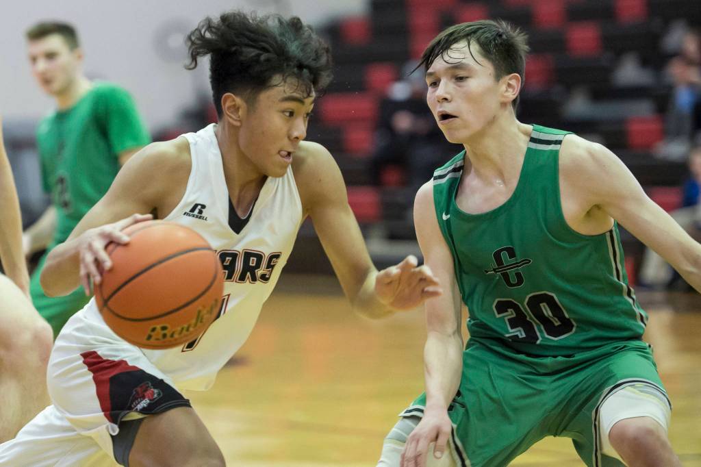 Juneau-Douglas Israel Yadao, left, drives against Colonys Jeremiah Hersrud at JDHS on Thursday, Jan. 10, 2019. Colony won 66-40. (Michael Penn | Juneau Empire}