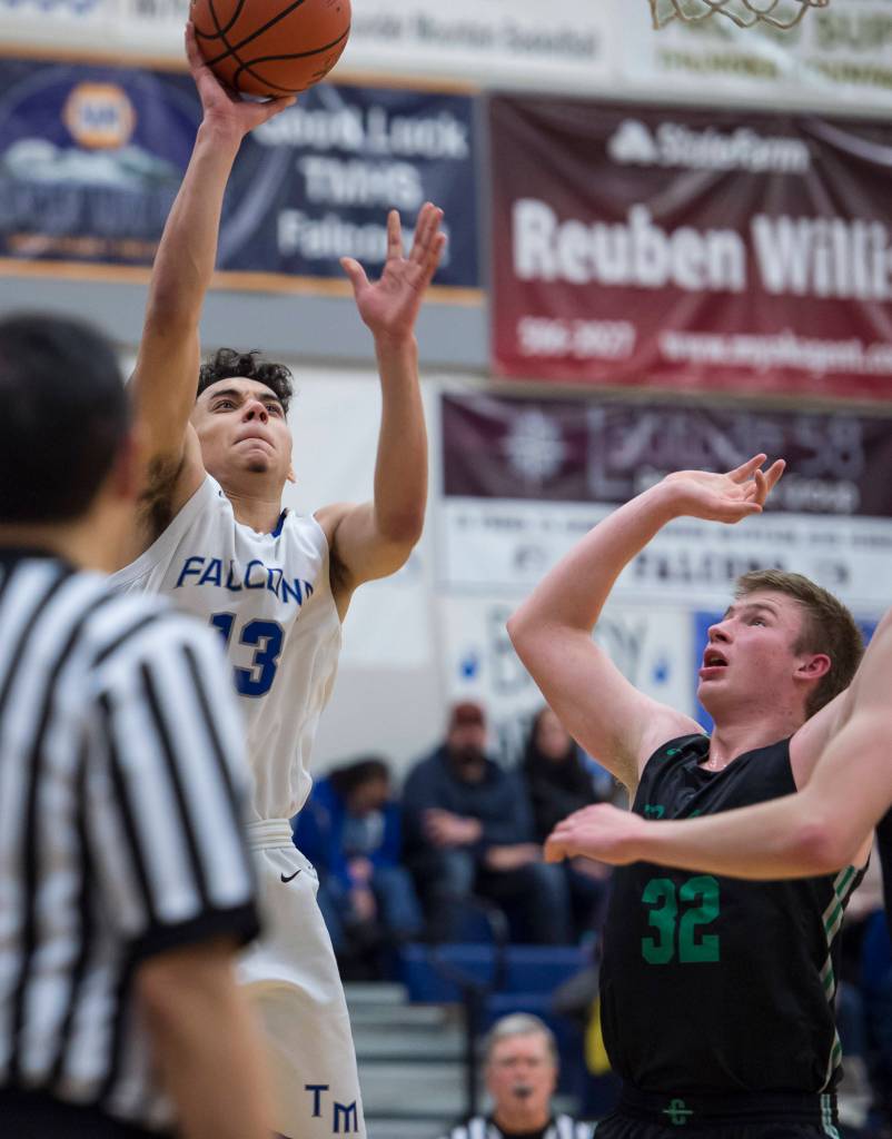 Thunder Mountains Kamron Falls, left, shoots against Colonys Wyatt Baker at TMHS on Friday, Jan. 11, 2019. Colony won 46-27. (Michael Penn | Juneau Empire)