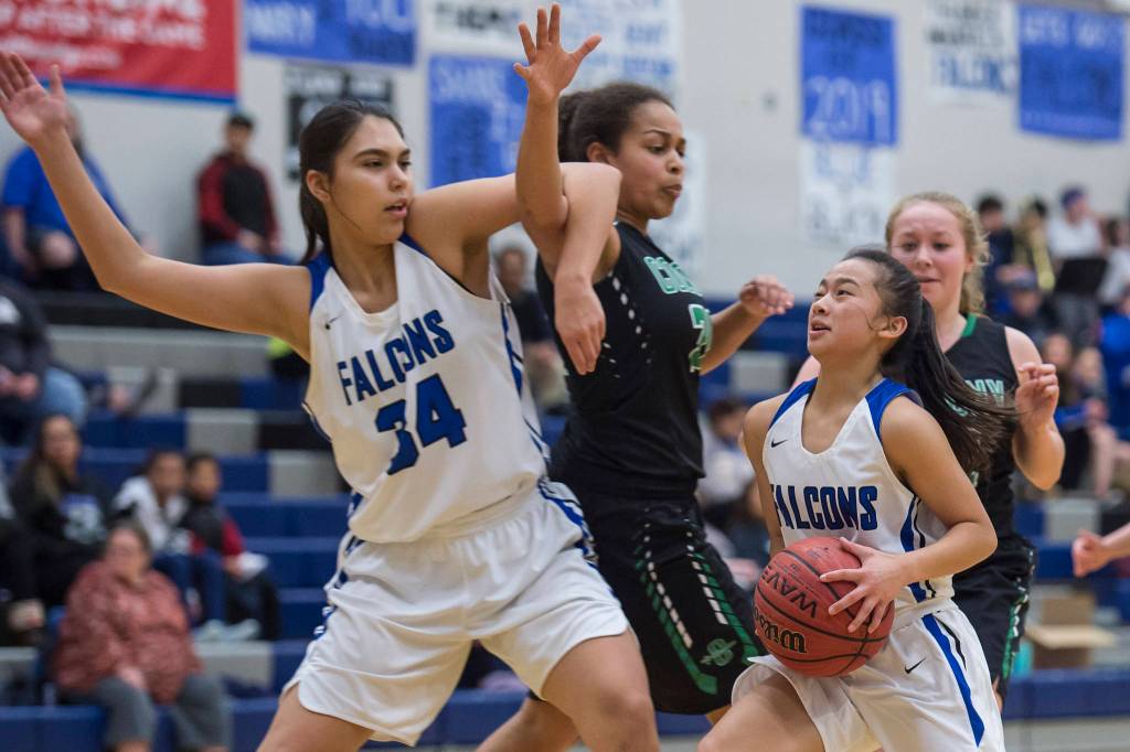 Thunder Mountains Mary Khaye Garcia, right, takes advantage of a pick against Colonys Kali Bull by teammate Kira Frommherz at TMHS on Friday, Jan. 11, 2019. Colony won 58-28. (Michael Penn | Juneau Empire)