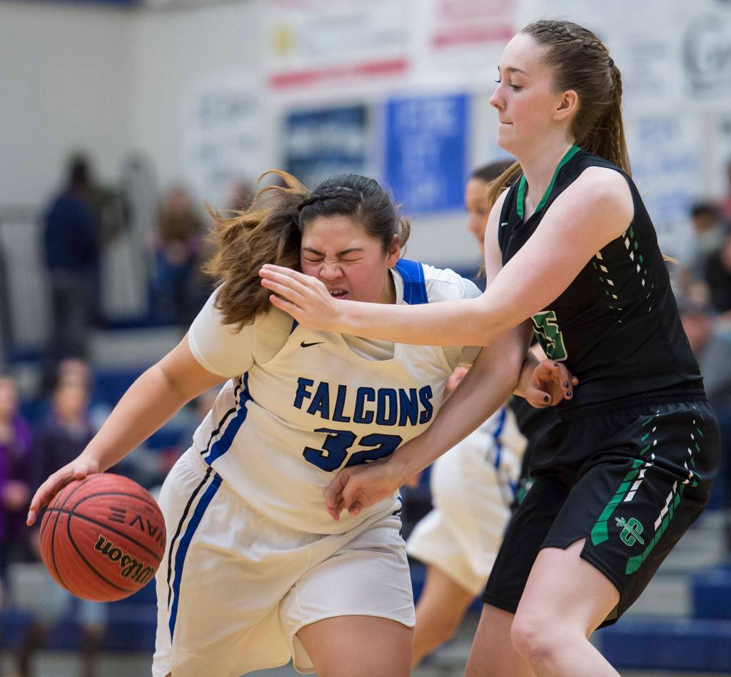 Thunder Mountains Nina Fenumiai, left, drives against Colonys Tori Schwantes at TMHS on Friday, Jan. 11, 2019. Colony won 58-28. (Michael Penn | Juneau Empire)