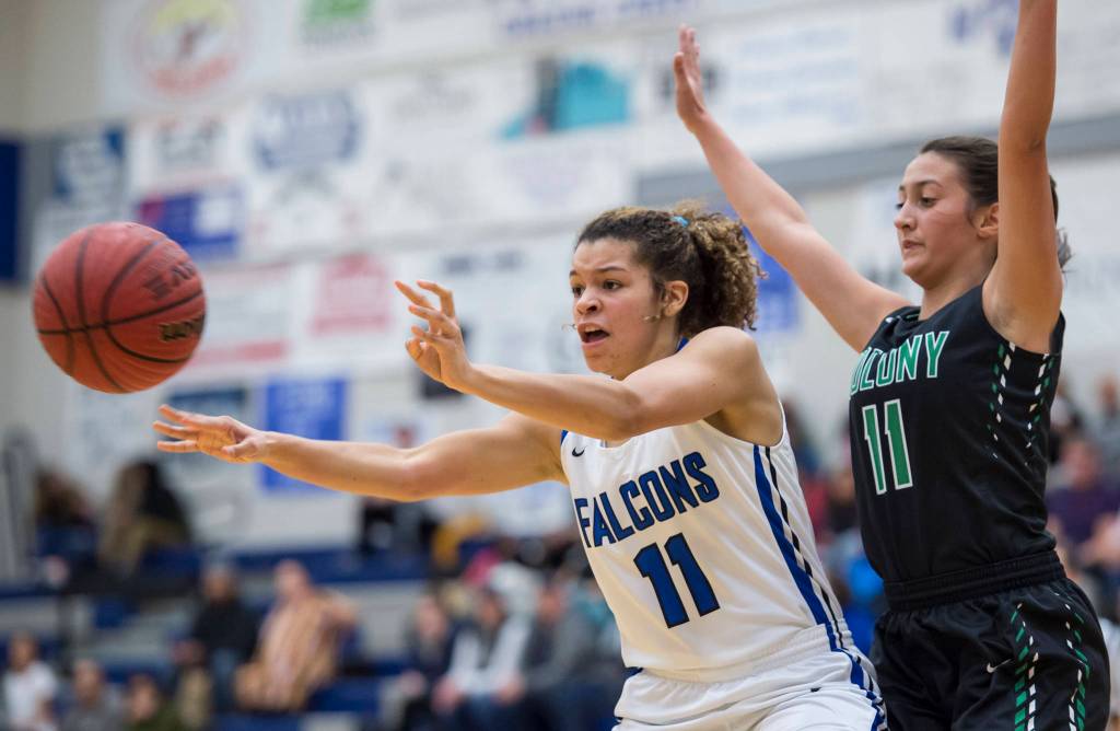 Thunder Mountains Tzadi Hauck, left, passes away from Colonys Madison Dunlop at TMHS on Friday, Jan. 11, 2019. Colony won 58-28. (Michael Penn | Juneau Empire)