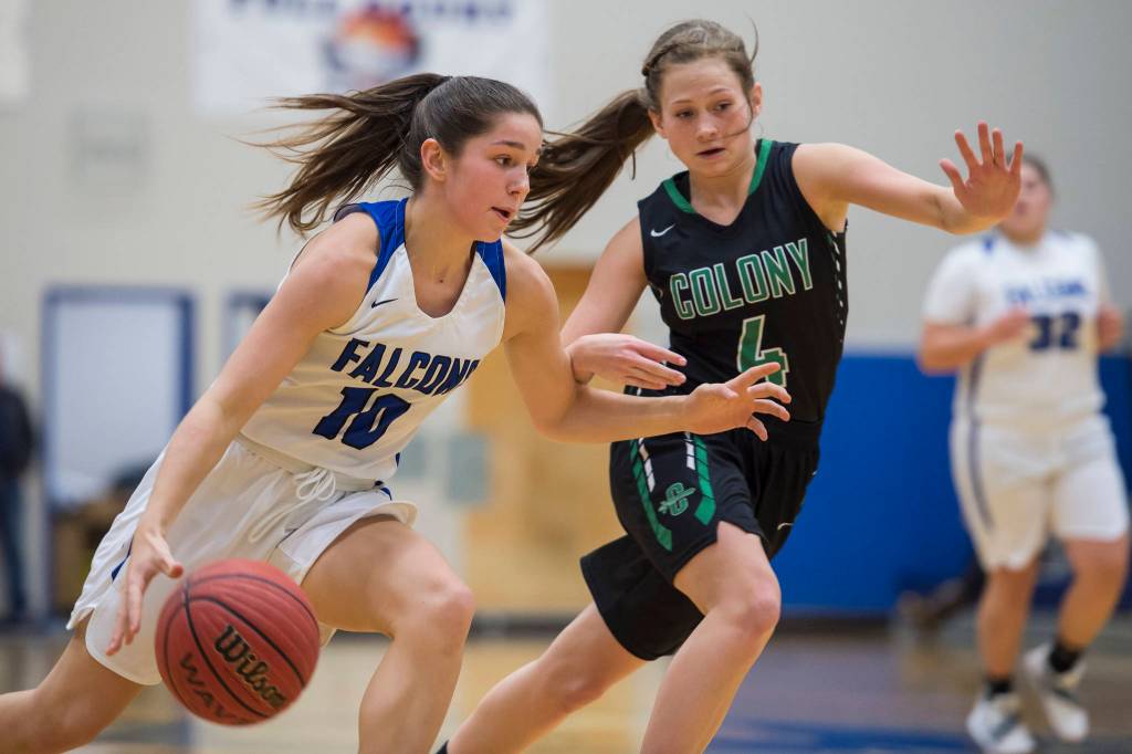 Thunder Mountains Riley Traxler, left, drives against Colonys Hannah Duguid at TMHS on Friday, Jan. 11, 2019. Colony won 58-28. (Michael Penn | Juneau Empire)