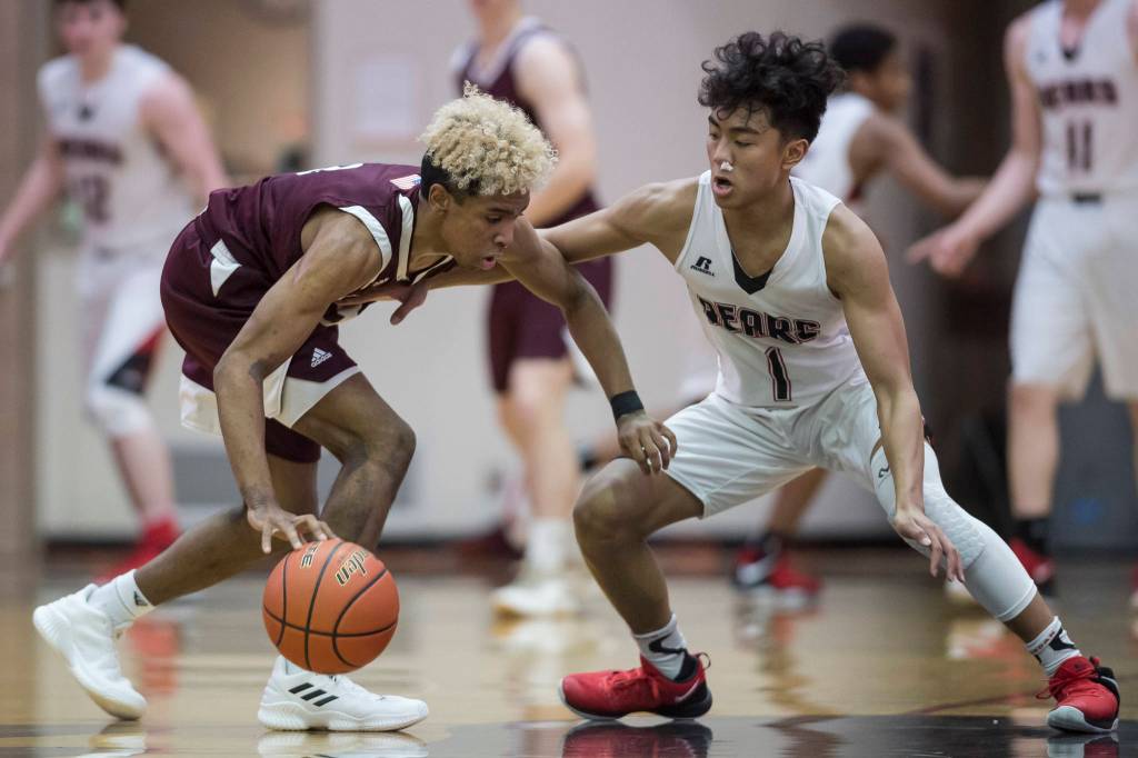 Juneau-Douglas Israel Yadao, right, guards against Ketchikans Marcus Lee at JDHS on Friday, Jan. 11, 2019. JDHS won 75-67. (Michael Penn | Juneau Empire)