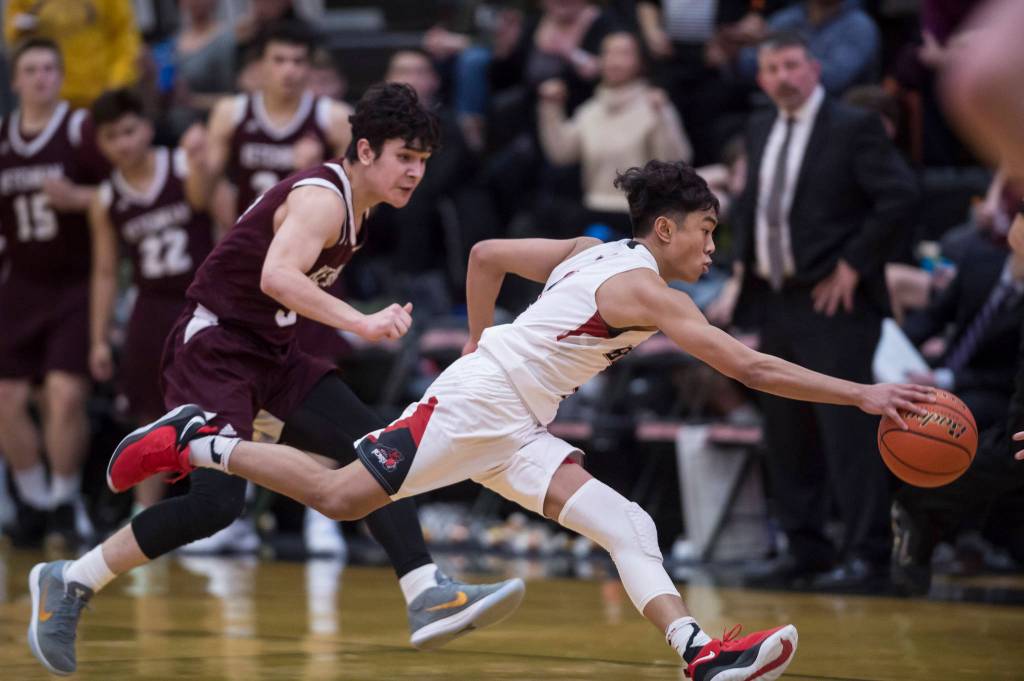 Juneau-Douglas Israel Yadao, right, races Ketchikans James Nordlund down the court at JDHS on Friday, Jan. 11, 2019. JDHS won 75-67. (Michael Penn | Juneau Empire)