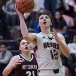 Juneau-Douglas Brock McCormick, right, lays the ball up against Ketchikans Kristian Pihl at JDHS on Friday, Jan. 11, 2019. JDHS won 75-67. (Michael Penn | Juneau Empire)