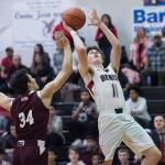 Juneau-Douglas Garrett Bryant shoots over Ketchikans Robert Hilton Seludo at JDHS on Friday, Jan. 11, 2019. JDHS won 75-67. (Michael Penn | Juneau Empire)
