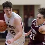 Juneau-Douglas Brock McCormick, left, drives against Ketchikans Kristian Pihl at JDHS on Friday, Jan. 11, 2019. JDHS won 75-67. (Michael Penn | Juneau Empire)