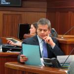 In this May 12, 2018 photo, Alaska House Minority Leader Chris Tuck looks over a document during a break in the Alaska House floor session in Juneau, Alaska. (Becky Bohrer | Associated Press File)