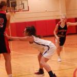 Juneau-Douglas Caitlin Pusich (22) attempts a pass as Bartletts Saravi Facine defends and Juneau-Douglas Sadie Tuckwood (4) and Bartletts Nyapar Mathot converge on the play during Thursday nights first-round game of the inaugural West Valley Ice Jam girls basketball tournament at West Valley High School. (Danny Martin | NEWS-MINER)