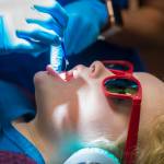 Tynly Booth, 8, holds still as Dr. Jessica Branco, of Juneau Pediatric Dentistry, applies a topical flouride varnish during a checkup on Monday, Jan. 14, 2019. (Michael Penn | Juneau Empire)