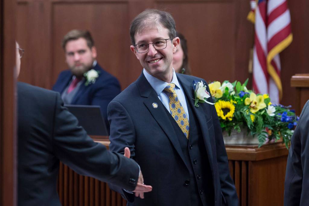 Sen. Jesse Kiehl is congratulated after being sworn in on the opening day of the 31st Session of the Alaska Legislature on Tuesday, Jan. 15, 2019. (Michael Penn | Juneau Empire)