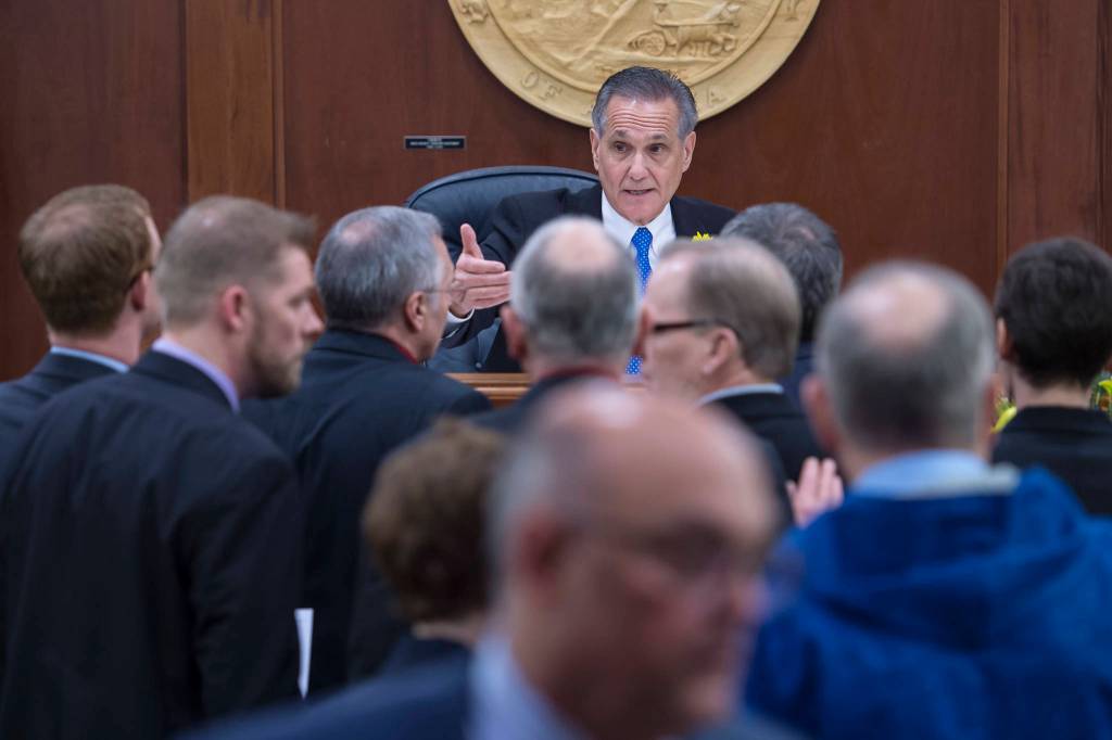 Republican Lt. Gov. Kevin Meyer, seated at the Speaker of the House chair, and Democratic legislators argue over what he can do on the first day of the 31st session of the Alaska Legislature on Tuesday, Jan. 15, 2019. (Michael Penn | Juneau Empire)