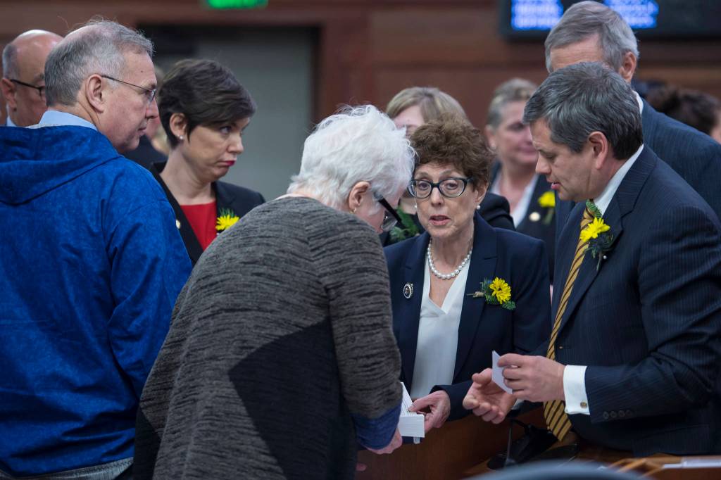 Democratic legislators huddle on the opening day of the 31st Session of the Alaska Legislature on Tuesday, Jan. 15, 2019. (Michael Penn | Juneau Empire)