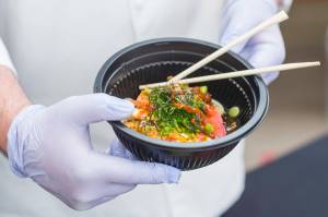 Chefs Matt Little Dog displays a dish featuring authentic Japanese ramen for students at Floyd Dryden Middle School as part of Chefs Day on Friday, Jan. 18, 2019. The Anchorage chefs visiting the Juneau and Sitka School Districts to introduced new and healthy foods via performance cooking demonstrations. (Michael Penn | Juneau Empire)