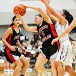 Juneau-Douglas player Trinity Jackson, left watches as teammate Kiana Potter, center, snags a rebound while Kayhis Shaelynn Mendoza gets involved in the play. JDHS won 50-35. (Hall Anderson | Ketchikan Daily News)