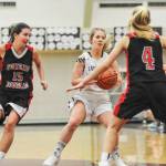 Juneau-Douglas players Jenae Pusich, left and Sadie Tuckwood, right, put the pressure on Kayhis Ashley Hufine in the first quarter Friday night at the Clarke Cochrane Gymnasium. JDHS won 50-35 over the Lady Kings. (Hall Anderson | Ketchikan Daily News)