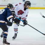 Juneau-Douglas Dalton Hoy, right, moves the puck against Homers Bergen Knutson at Treadwell Arena on Friday, Jan. 18, 2019. JDHS won 4-3 in overtime. (Michael Penn | Juneau Empire)