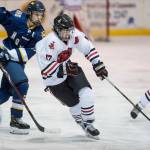 Juneau-Douglas Bill Bosse, right, moves the puck against Homers Ethan Pitzman at Treadwell Arena on Friday, Jan. 18, 2019. JDHS won 4-3 in overtime. (Michael Penn | Juneau Empire)