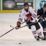 Juneau-Douglas Cameron Smith drives against Homers Tyler Gilliland at Treadwell Arena on Friday, Jan. 18, 2019. JDHS won 4-3 in overtime. (Michael Penn | Juneau Empire)