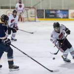 Juneau-Douglas Bill Bosse, right, moves the puck against Homers Ethan Pitzman at Treadwell Arena on Friday, Jan. 18, 2019. JDHS won 4-3 in overtime. (Michael Penn | Juneau Empire)