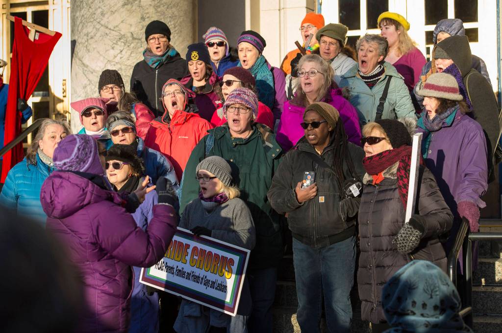 Members of the Juneau Pride Chorus sing at the start of the Womens March on Juneau in front of the Alaska State Capitol on Saturday, Jan. 19, 2019. (Michael Penn | Juneau Empire)