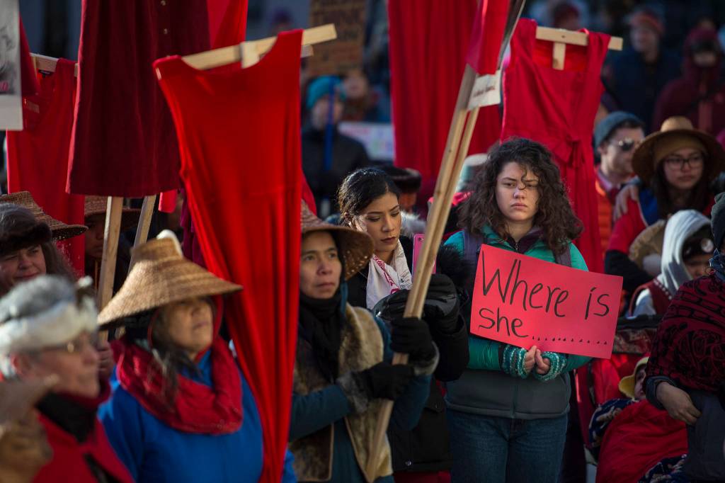 Native women hold up red dresses to symbolize missing and murdered indigenous women during the Womens March on Juneau in front of the Alaska State Capitol on Saturday, Jan. 19, 2019. (Michael Penn | Juneau Empire)                                Native women hold up red dresses to symbolize missing and murdered indigenous women during the Womens March on Juneau in front of the Alaska State Capitol on Saturday, Jan. 19, 2019. (Michael Penn | Juneau Empire)