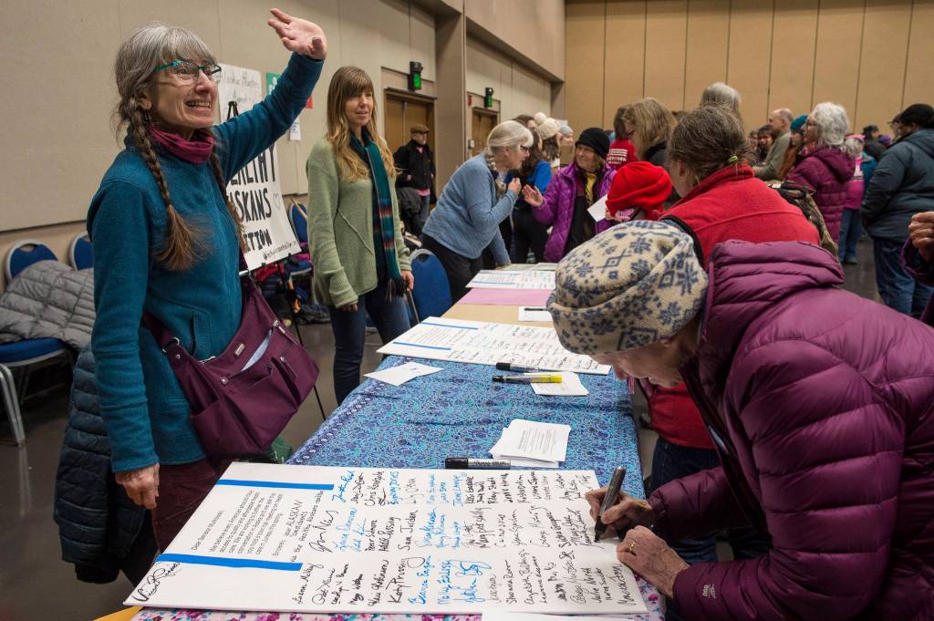 Luann McVey, left, and Julie Nielsen gather signatures for a universal health care letter to be sent to Sen. Lisa Murkowski after the Womens March on Juneau at Centennial Hall on Saturday, Jan. 19, 2019. (Michael Penn | Juneau Empire)