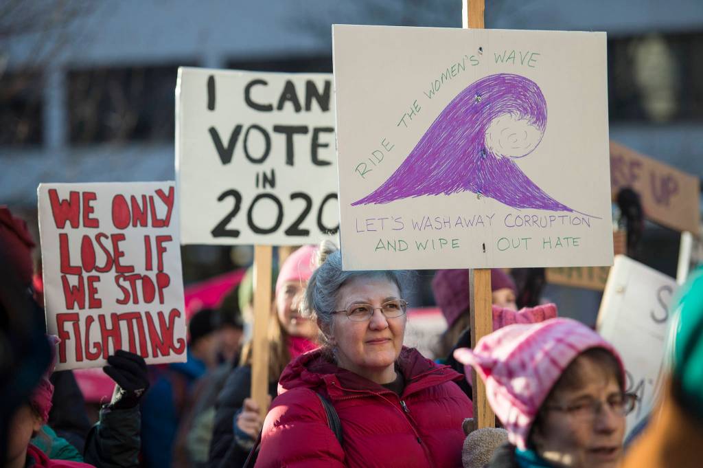 City and Borough of Juneau Assembly member Michelle Bonnet Hale holds a sign at the Womens March on Juneau in front of the Alaska State Capitol on Saturday, Jan. 19, 2019. (Michael Penn | Juneau Empire)