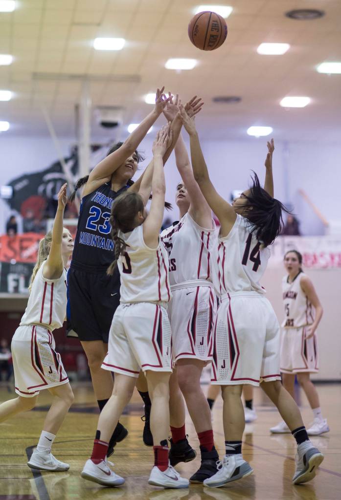 Thunder Mountains Kira Frommherz shoots over Juneau-Douglas players at JDHS on Friday, March 3, 2018. JDHS won 53-33. (Michael Penn | Juneau Empire File)