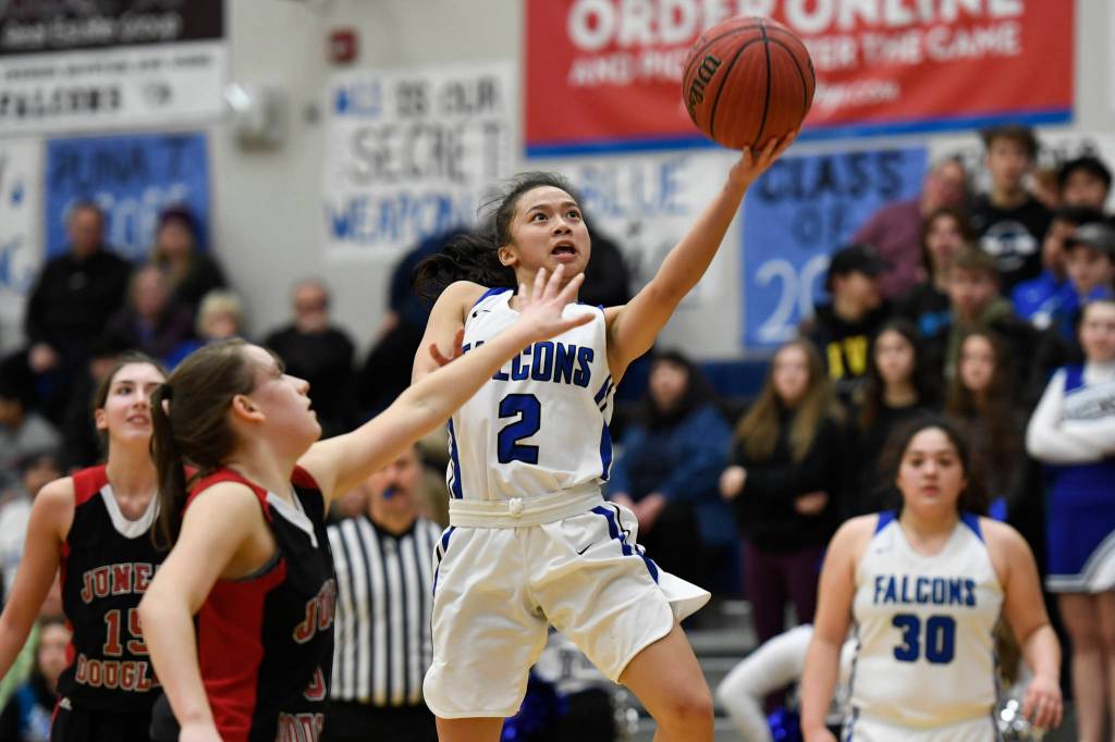 Thunder Mountains Mary Khaye Garcia lays the ball up against Juneau-Douglas Kiana Potter at TMHS on Friday, Feb. 1, 2019. (Michael Penn | Juneau Empire)