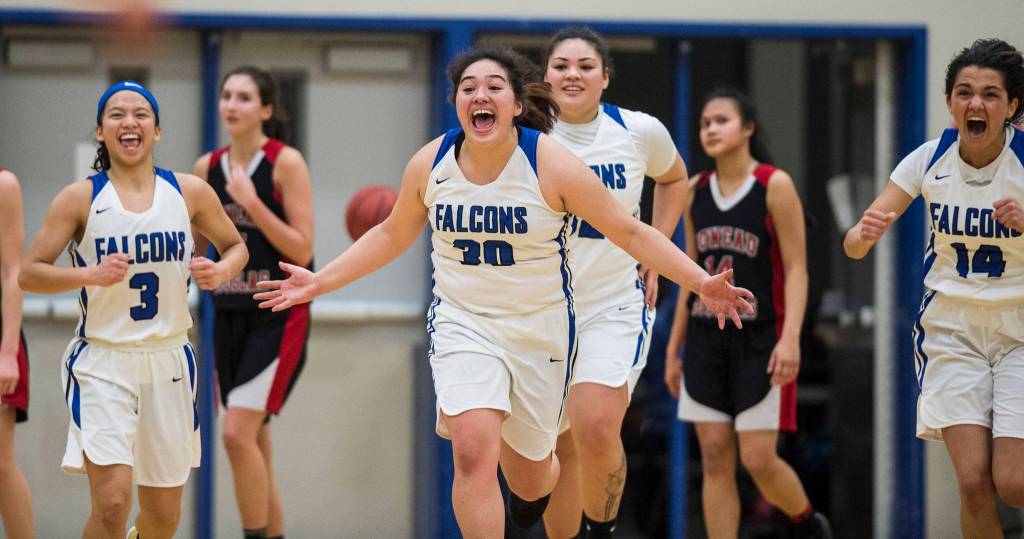 Thunder Mountains Mary Neal Garcia, left, Tasi Fenumiai, Nina Fenumiai and Charlee Lewis, right celebrate their win 40-36 over Juneau-Douglas at TMHS on Friday, Feb. 1, 2019. (Michael Penn | Juneau Empire)