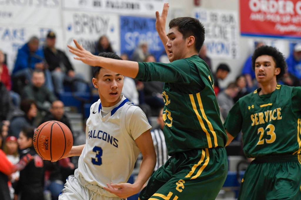 Thunder Mountains Bryson Echiverri drives against Services Brandon Mills at TMHS on Friday, Feb. 1, 2019. (Michael Penn | Juneau Empire)