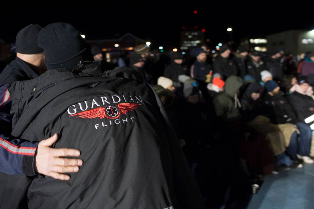 Hundreds of Juneau residents turnout Friday, Feb. 1, 2019, in 8-degree weather for a candlelight vigil at Mayor Bill Overstreet Park for the Guardian medical flight crew that went missing this week. (Michael Penn | Juneau Empire)